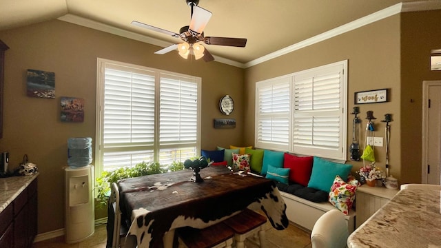 dining space featuring ornamental molding, vaulted ceiling, and ceiling fan