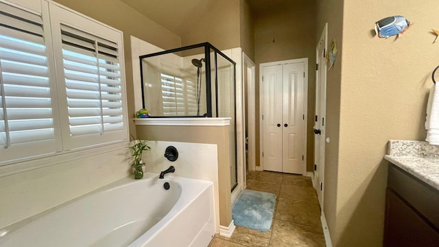 bathroom with vanity and separate shower and tub