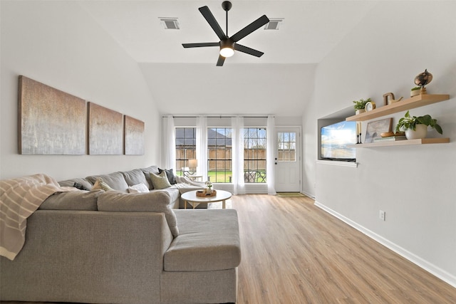 living area featuring visible vents, light wood-style flooring, a ceiling fan, baseboards, and vaulted ceiling