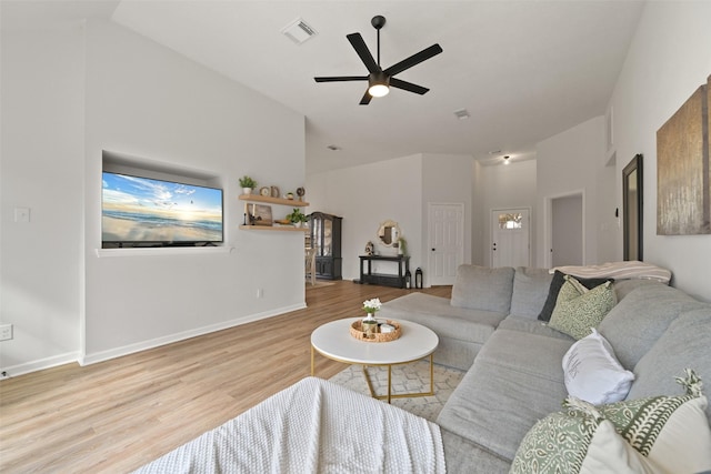 living room featuring visible vents, baseboards, ceiling fan, and wood finished floors