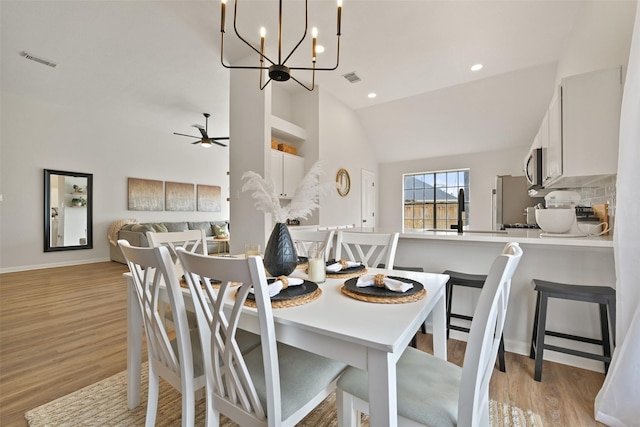 dining area featuring visible vents, light wood-style flooring, and ceiling fan