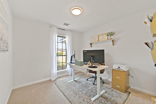 home office featuring light carpet, visible vents, and baseboards