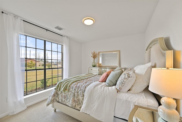 carpeted bedroom with visible vents and baseboards