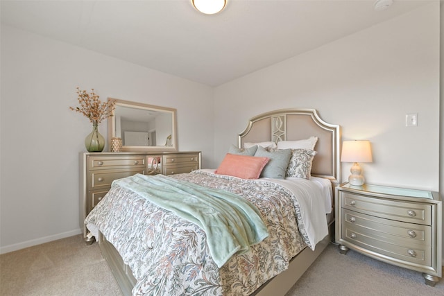 bedroom with baseboards and carpet