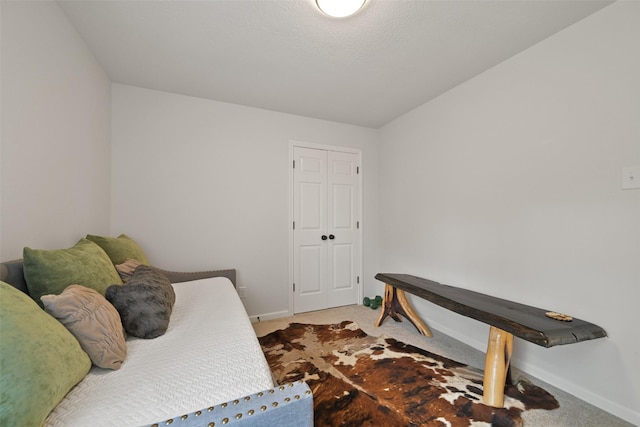 bedroom featuring baseboards and carpet floors