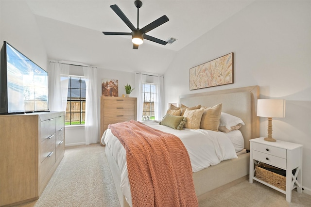 bedroom featuring vaulted ceiling, light colored carpet, visible vents, and baseboards