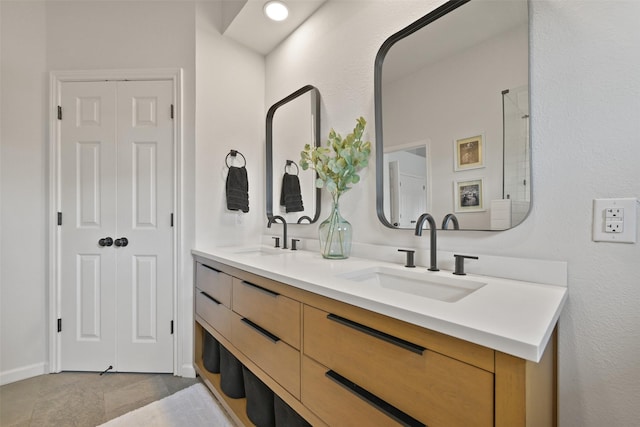 bathroom with a sink and double vanity