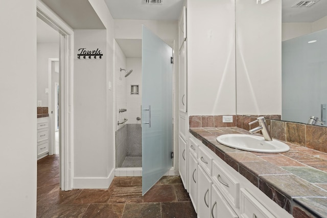 bathroom featuring vanity and an enclosed shower