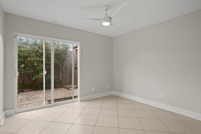 empty room with ceiling fan and light tile patterned floors