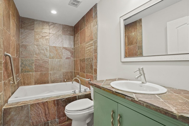 full bathroom with tiled shower / bath combo, vanity, and toilet