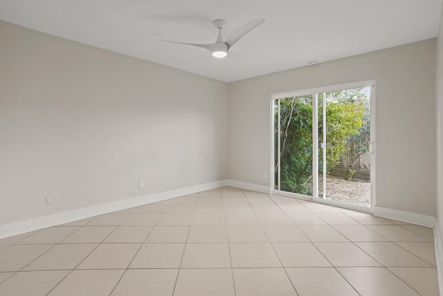 tiled spare room featuring ceiling fan