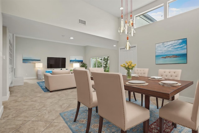 tiled dining room with a towering ceiling