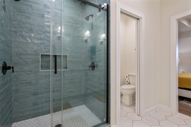 bathroom with walk in shower, toilet, and tile patterned flooring