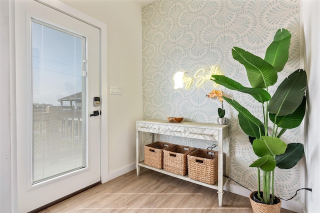 doorway with hardwood / wood-style flooring