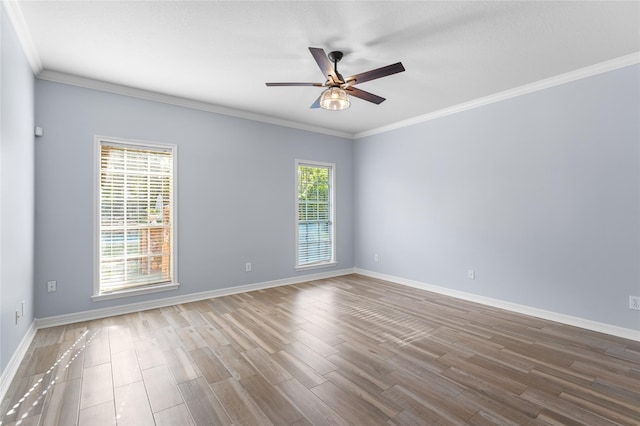 unfurnished room with ornamental molding, a ceiling fan, baseboards, and wood finished floors