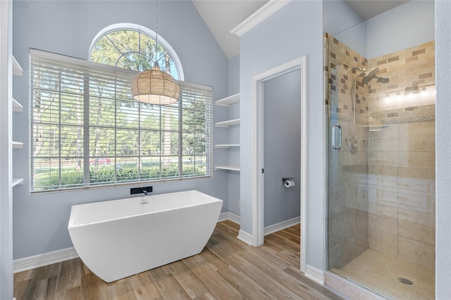 full bathroom featuring a wealth of natural light, a stall shower, lofted ceiling, and wood finished floors