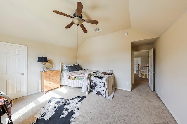 bedroom featuring ceiling fan, light colored carpet, and vaulted ceiling