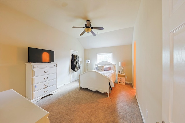 carpeted bedroom featuring ceiling fan, lofted ceiling, and a closet