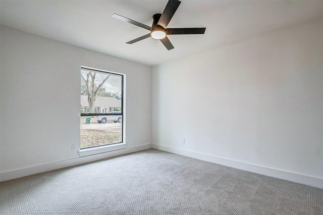 empty room featuring carpet floors and ceiling fan