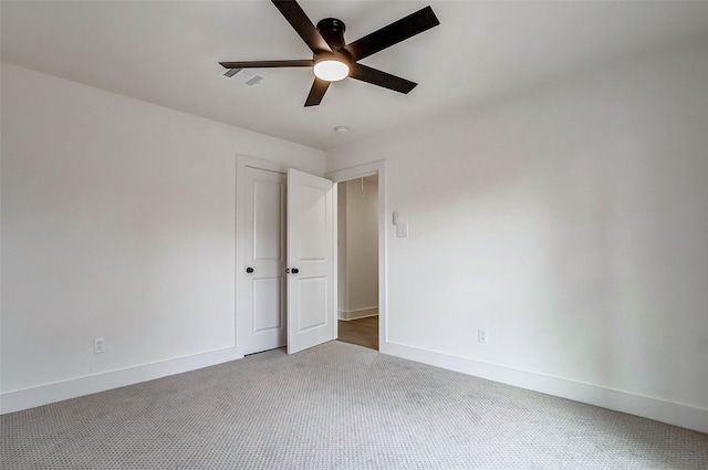 carpeted empty room with ceiling fan