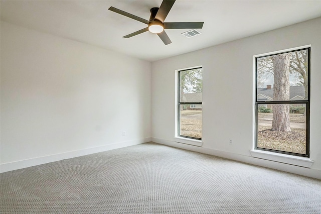 carpeted spare room featuring ceiling fan