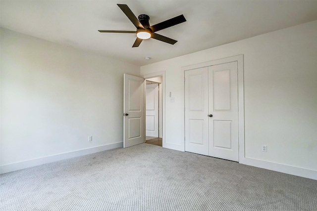 unfurnished bedroom with ceiling fan, carpet floors, and a closet