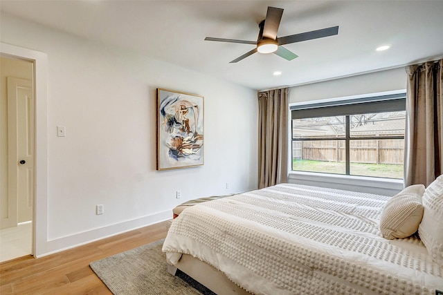 bedroom with light hardwood / wood-style floors and ceiling fan