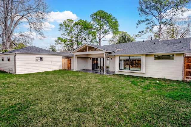 rear view of house with a yard and a patio