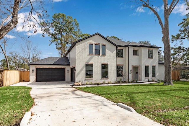 view of front of property featuring a garage and a front yard