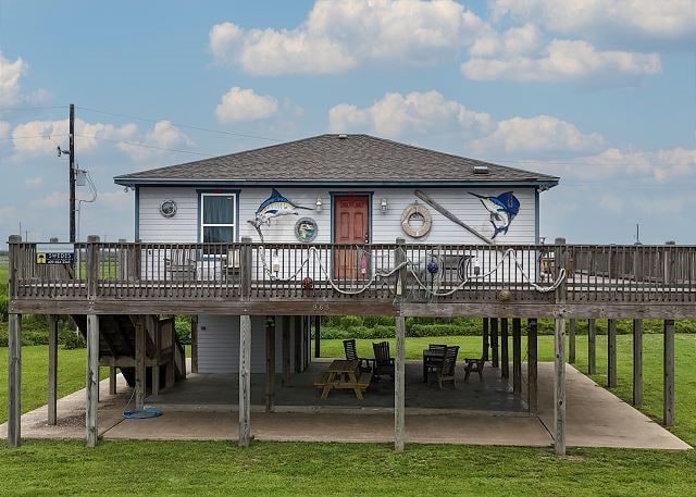 back of house featuring a yard, a deck, and a patio area