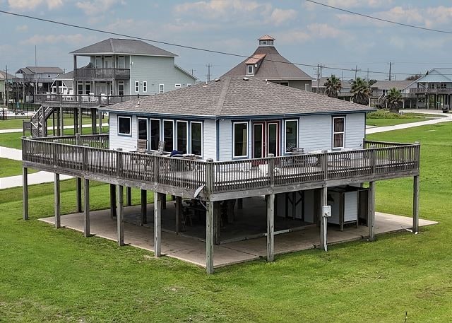 back of house featuring a patio area, a deck, and a lawn