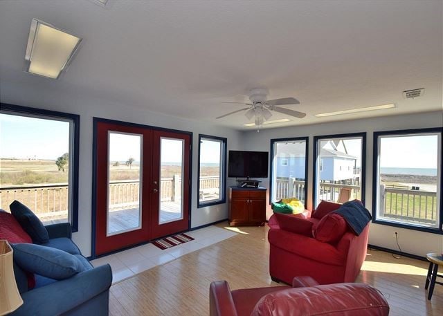 living room with ceiling fan, light wood-type flooring, and french doors