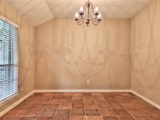 tiled spare room featuring vaulted ceiling, a healthy amount of sunlight, a textured ceiling, and a chandelier