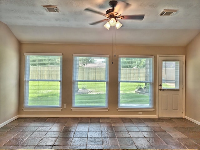 doorway to outside featuring ceiling fan and lofted ceiling