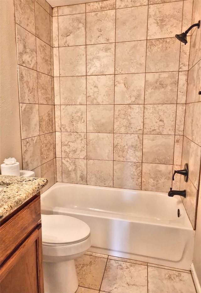 full bathroom with tiled shower / bath combo, vanity, and toilet