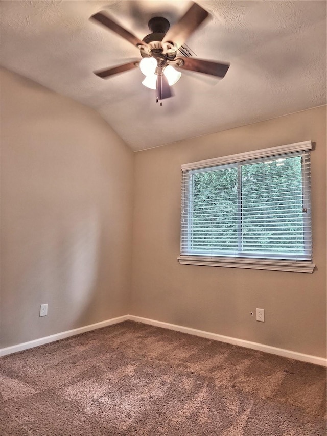 unfurnished room with a textured ceiling, carpet floors, ceiling fan, and vaulted ceiling