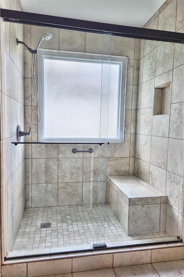 bathroom featuring a shower with shower door