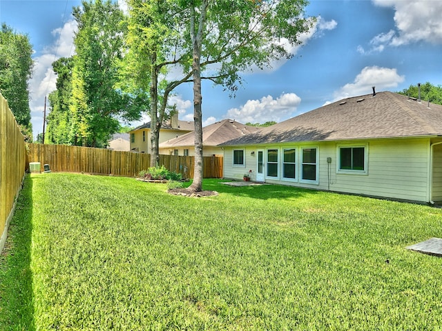 rear view of property featuring a lawn