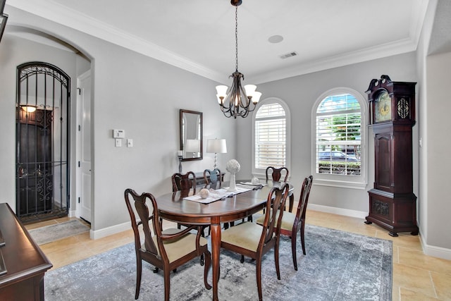 dining space featuring an inviting chandelier and crown molding