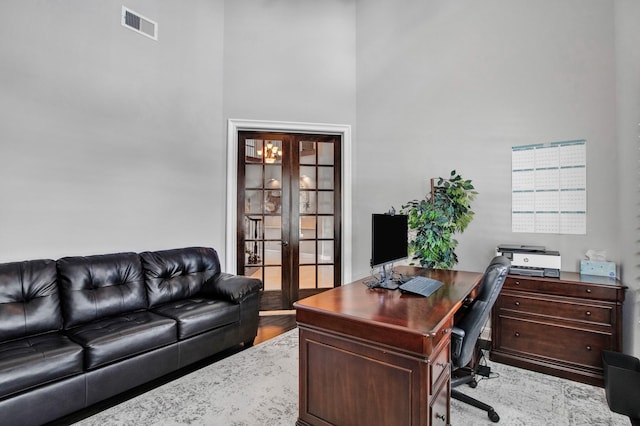 home office with french doors and a high ceiling