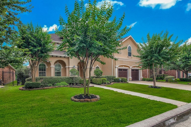 view of front of home with a garage and a front yard