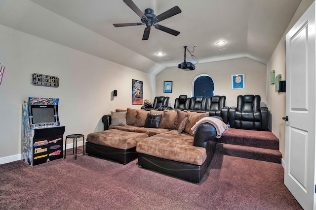 carpeted home theater room with ceiling fan and vaulted ceiling