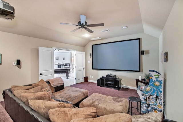 cinema room featuring vaulted ceiling, ceiling fan, and dark colored carpet