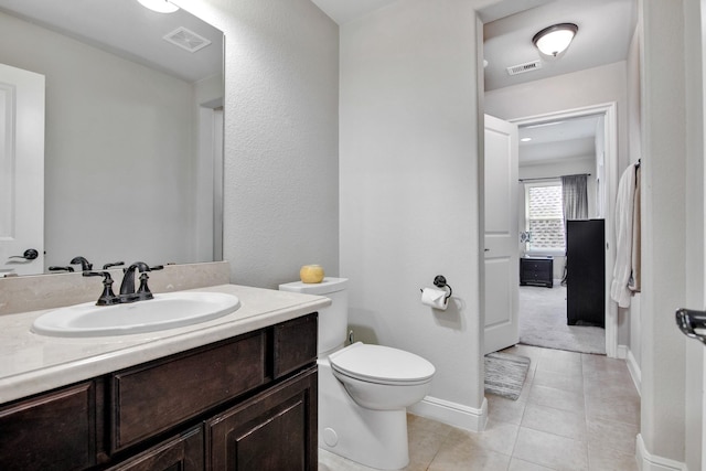 bathroom with tile patterned floors, toilet, and vanity