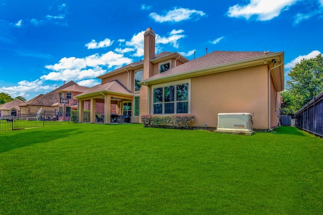 rear view of property with cooling unit and a lawn