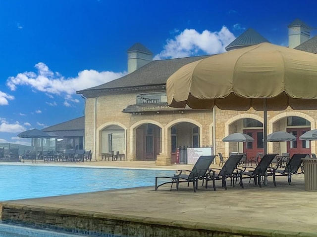 view of pool featuring a patio area