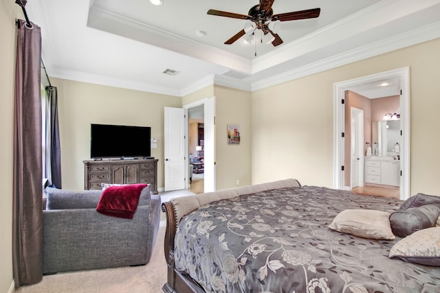 carpeted bedroom featuring crown molding, ceiling fan, connected bathroom, and a tray ceiling