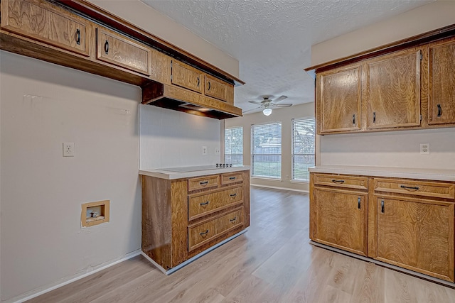 kitchen with light countertops and brown cabinetry