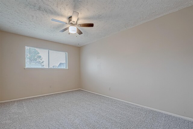 carpeted spare room with a textured ceiling and ceiling fan