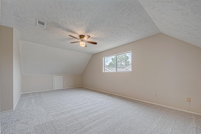 bonus room with visible vents, carpet flooring, and vaulted ceiling